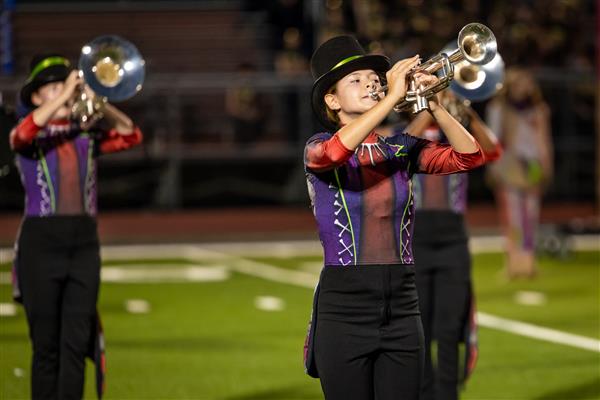 Ravenwood High band members march